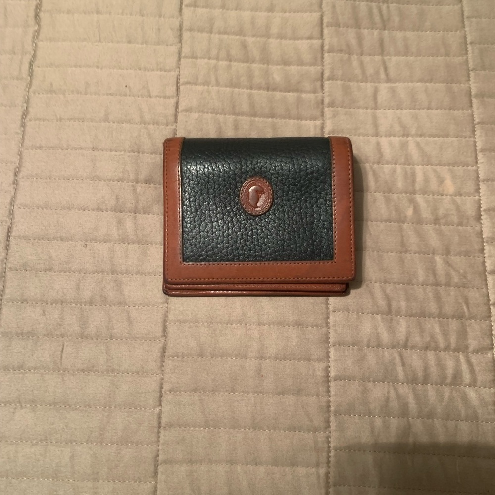 Dooney and Burke blue and tan trim wallet. Slightly used.